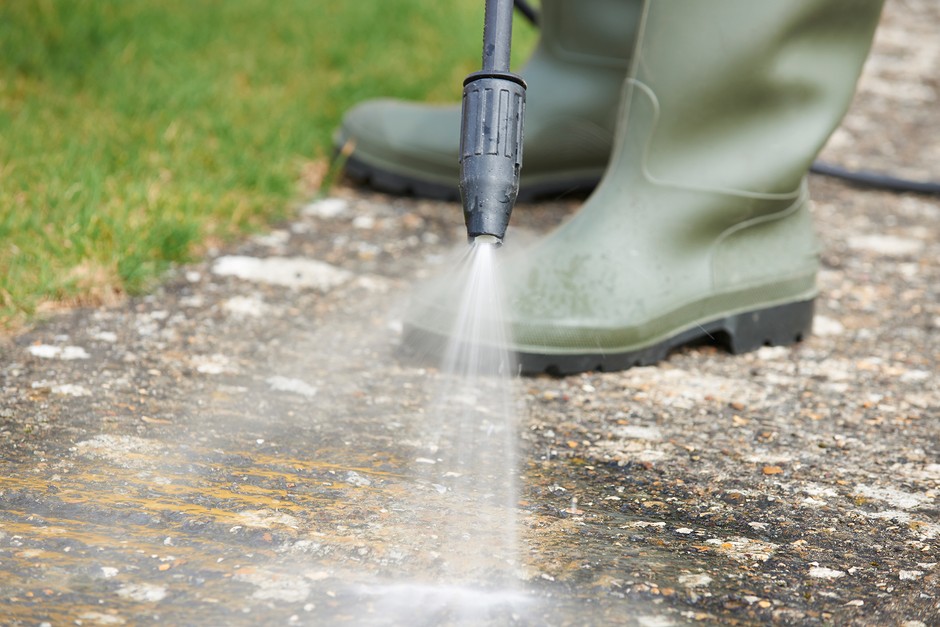 Using a pressure washer to clean a patio. Getty Images Using a pressure washer to clean a patio. Getty Images